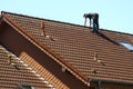 Roofer is working on a roof