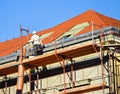Roofer works on the roof of an old building Royalty Free Stock Photo