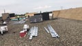 Roofers and a crew repairing a commercial flat roof and materials, tools and supplies Royalty Free Stock Photo