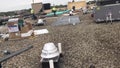 Roofers repairing areas of a commercial flat roof and materials, tools and supplies