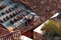 Roofers repairing the tiled roof of a historic building in KaleiÃÂ§i, Antalya