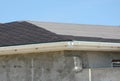 Roofing constraction. Install house roof gutter and laying asphalt shingles. Royalty Free Stock Photo