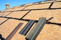 Roofing construction. Preparing a osb roof deck with bitumen waterproofing in cracks before underlayment, felt paper and asphalt