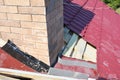 Roofing Construction. Repair roof with insulation and waterproofing chimney area. Royalty Free Stock Photo