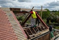 Building worker in a green hi vis jacket doing buildng work at a residential property in northwest London UK.