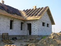 Roofing House Exterior. A roof under construction site with stacks of roof tiles ready to fasten outdoor