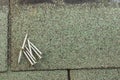 Roofing nails on shingle Royalty Free Stock Photo