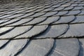 Roofing: pattern of gray slate on an antique roof lightend by th