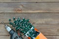 Roofing screws and a drill on a wooden table. The view from the top. Template for labor day .Roofer, roofing work Royalty Free Stock Photo