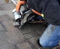 ROOFING WORK: professional roofer repairs shingles.