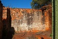 ROOFLESS ROOM IN AN OLD FORT IN RUIN AGAINST A BLUE SKY WITH DETAIL OF GREEN PAINTED METAL STRUCTURE