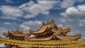The roofs of a Chinese temple against a blue sky and clouds. Royalty Free Stock Photo