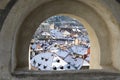 Roofs covered with snow thru window of wall in Cesky Krumlov Royalty Free Stock Photo