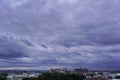 Roofs of houses and a Church at sunset, the dark sky with clouds before a thunderstorm. old town top view. the observation deck on