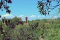 Roofs of the monastery between the trees from the Paseo de la Olmeda. Royalty Free Stock Photo