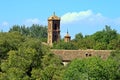 Roofs of the monastery between the trees from the Paseo de la Olmeda. Royalty Free Stock Photo