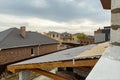 Roofs of new houses under construction in cottage village. Royalty Free Stock Photo