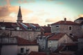 Roofs of Old European city skyline with orange tile and tower in front of dramatic sunset sky with antique architecture in old Eur Royalty Free Stock Photo