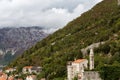 Roofs of old houses in Perast and Bay with mountains in Montenegro