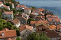 Roofs of old houses in Perast and Bay with mountains in Montenegro