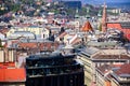 Roofs of residential and church buildings in Budapest. blurred hilly landscape beyond