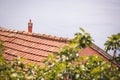 Roofs by sea against clear blue sky. Fragment of old weathered ceramic red tile roof Royalty Free Stock Photo
