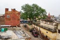 The roofs in a slum in Agra, India near the famous Taj Mahal with a lot of garbage, mess and broken stuff around showing the