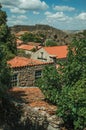 Roofs of stone old houses with leafy treetops Royalty Free Stock Photo