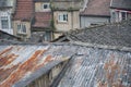 Roofs with traditional clay tiles and rusty corrugated iron in Chinese city