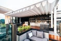 Rooftop bar with white movable roof and outdoor sofa