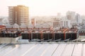 Rooftop of building HVAC Air Chillers with solar panel. modern Bangkok city landscape