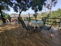 A rooftop cafe that has steel tables and steel chairs on the wooden tiles Royalty Free Stock Photo