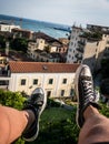 Rooftop feet dangling on italy coastline Royalty Free Stock Photo