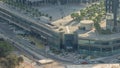 Rooftop garden with palms near entrance to office towers in financial district of Dubai city timelapse