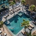 Luxury Resort Pool Day Aerial View of Couple Relaxing by Turquoise Water and Palm Trees Royalty Free Stock Photo