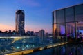 Rooftop restaurant with modern city view at dusk Royalty Free Stock Photo