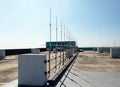 Rooftop small radio panel communication tower antenna and television. Royalty Free Stock Photo