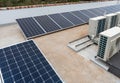 Rooftop solar panels and air conditioning on top of an apartments