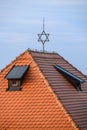 Rooftop of synagogue with a star of David symbol, against a clear blue sky Royalty Free Stock Photo