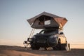 Rooftop tent for camping on the roof rack of an off-road SUV car in a desert Royalty Free Stock Photo