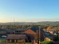 Rooftop view of houses in Huddersfield, England with Emley Moor Mast in the background