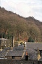 Rooftop view of rows of traditional terraced streets and stone houses in hebden bridge west yorkshire and surrounding woodland