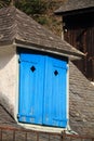 Rooftop window with blue wooden shutter of a mountain hut, pyrenees, south france Royalty Free Stock Photo
