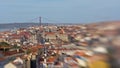 Rooftops of the houses of Lisbon and Carmo convent ruin, with Tagus river in the background, artistic impression with Lensbaby len