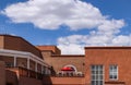 Rooftops of Santa Fe New Mexico Looking across the street from on rooftop to stucco buildings with balconies and a bright red um Royalty Free Stock Photo