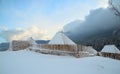 Rooftops of wood cabins under the snow