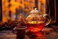 rooibos tea steeping in a glass teapot by the warm campfire glow
