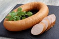 Rookworst sausage and basilÃÅ½ on slate cutting board