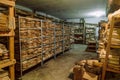 Room of an abandoned soviet administrative building with old archival paper documents on racks in piles