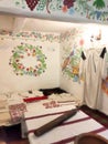 a room in an ancient Ukrainian house with painted walls and embroidered towels